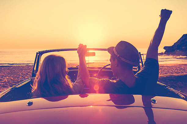 istock Couple watching the sunset in a convertible car. 637188034