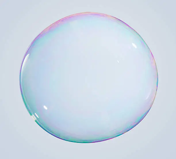 Iredescent Soap bubble on a white/grey background