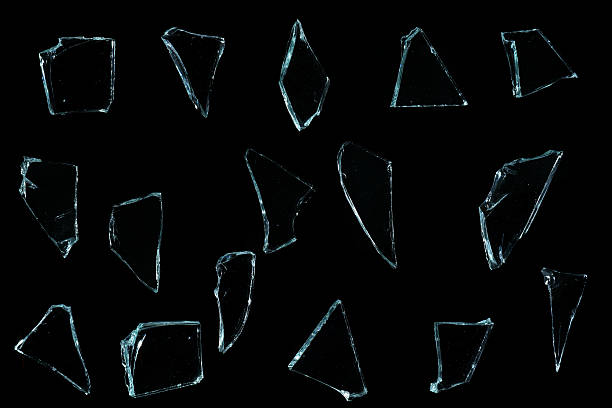 istock Shattered glass pieces on black background 637189304