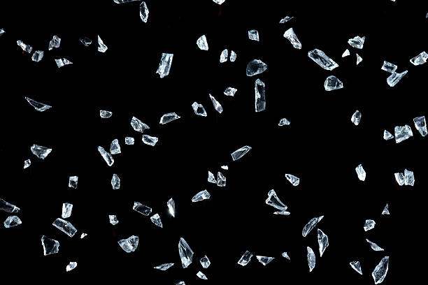istock Shattered glass pieces on black background 637189388