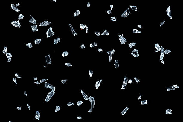 istock Shattered glass pieces on black background 637189400