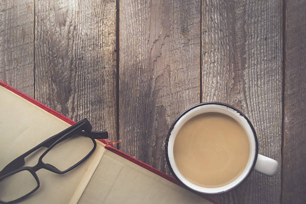 istock Open Book with Coffee and Glasses on Wooden Background 637192958