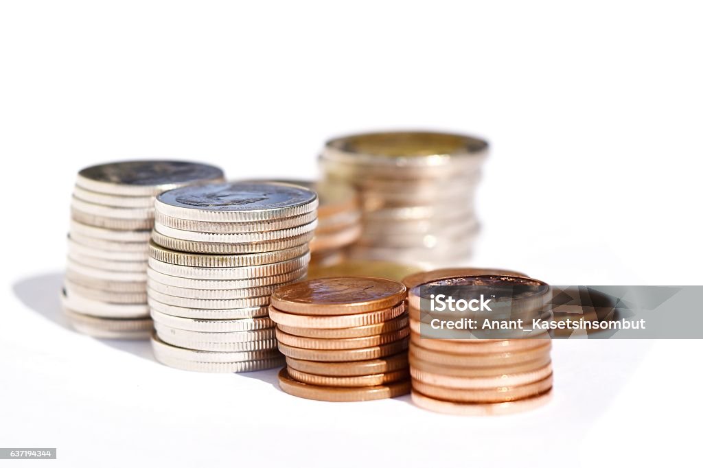 Many stacks of coins in various sizes and valued Stacks coins row on white background Banking Stock Photo