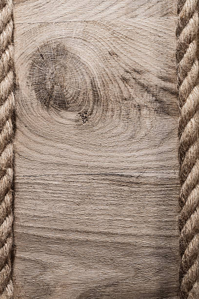 istock Vintage hemp cables on wooden board vertical version 637194566