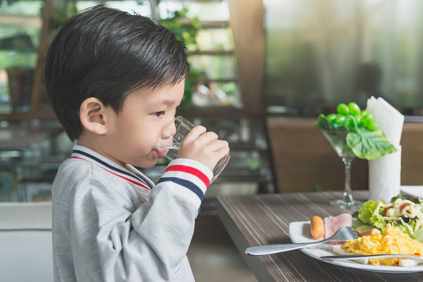 istock Cute Asian child drinking water 637196158