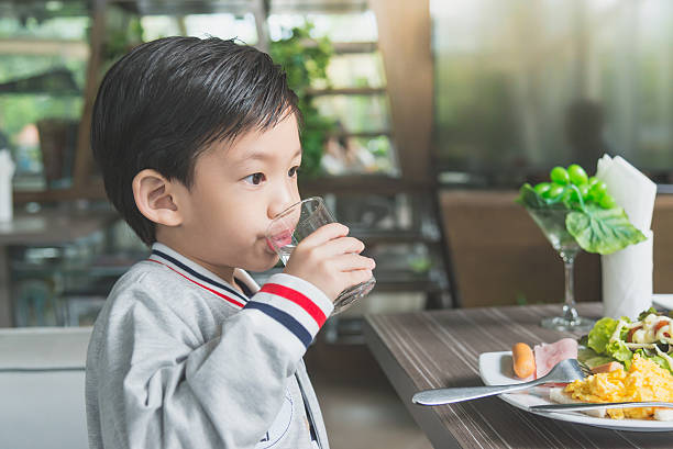 istock Cute Asian child drinking water 637196164