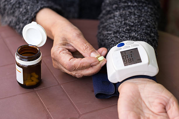 Senior woman measuring blood pressure,hypertensive stock photo