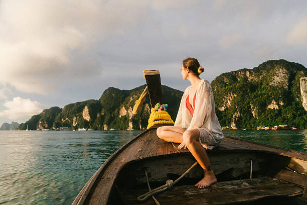 istock Woman sitting on long tail boat 637201352