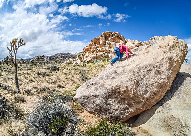 Girl Climbing Large Rock stock photo