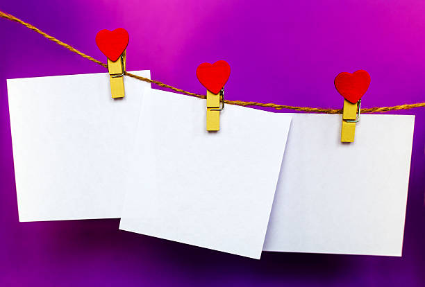istock White paper stickers hanging on heart shape pins and pack-thread 637206030
