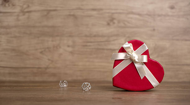 istock Gift box on the wooden background. Valentine's Day gift. Red box. 637206544