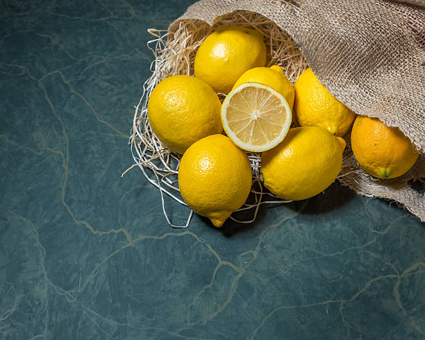 istock Fresh lemons stacked on hessian sack 637207488