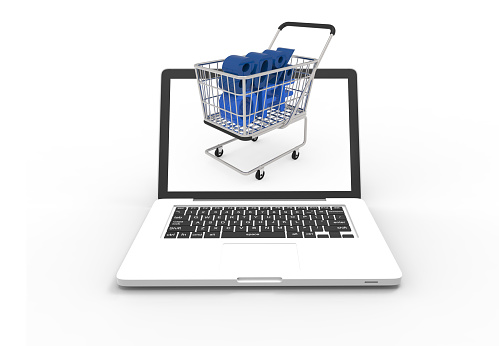 Shopping trolley in laptop computer on white background, concept of online shopping