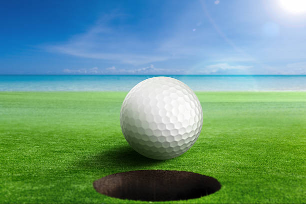 istock Golf Ball on edge of the hole. 637207674