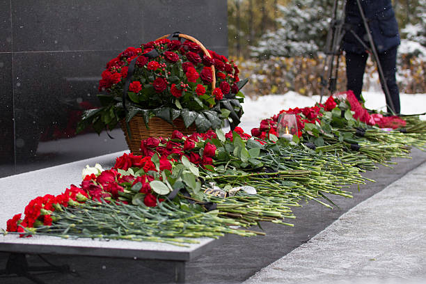 istock Red flower on the monument at the funeral ceremony 637211698