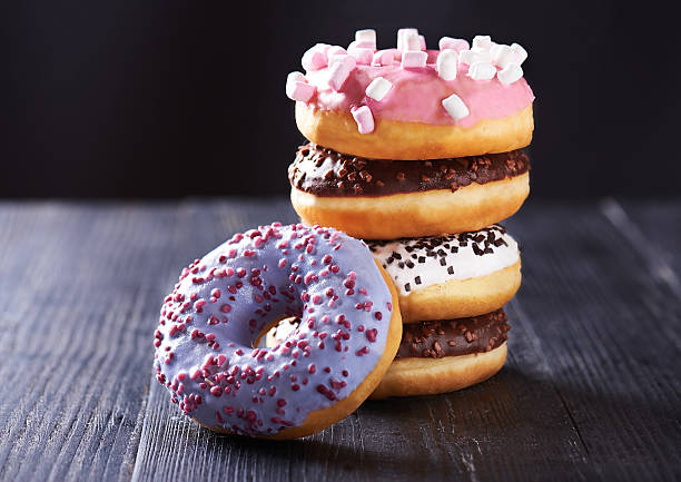 istock Variety of donuts with icing on a dark background 637211798
