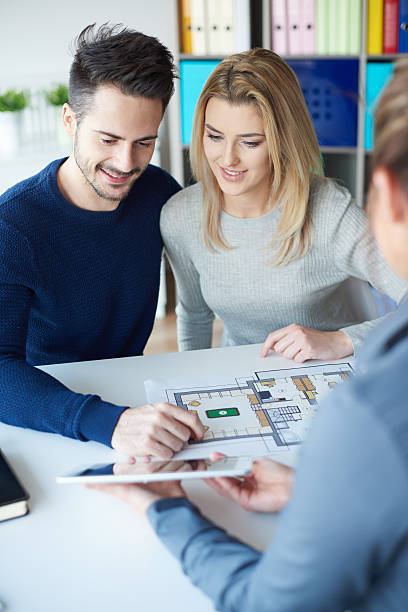istock Business woman having conversation with couple 637214572