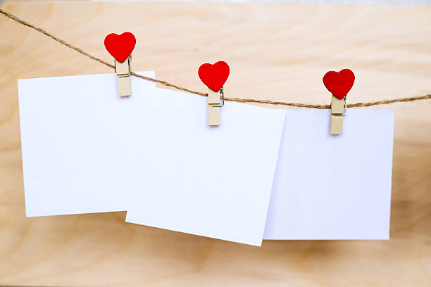 istock White paper stickers hanging on heart shape pins and pack-thread 637214942