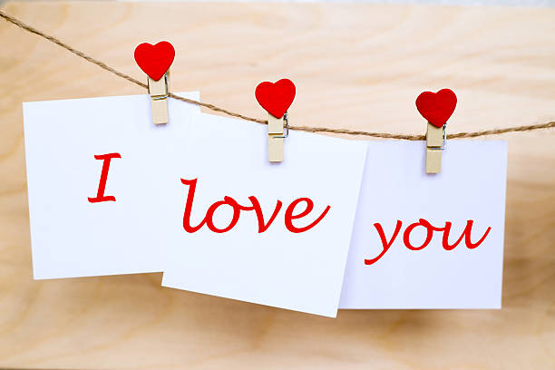 istock Love you text on stickers hanging on heart shape pins 637215124