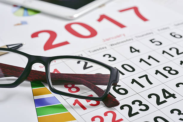 istock eyeglasses, charts and 2017 calendar 637222346