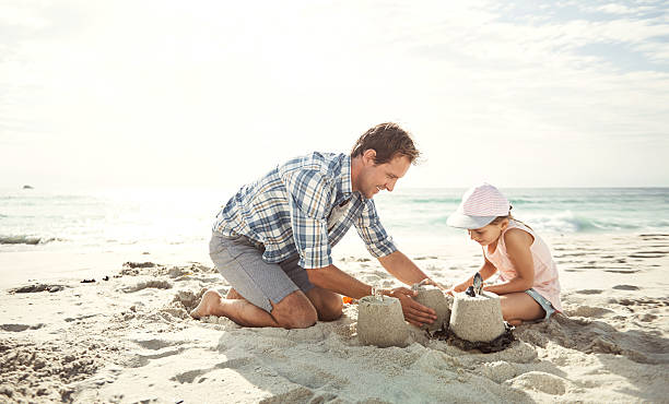 istock Building a sand castle with his little princess 637222670