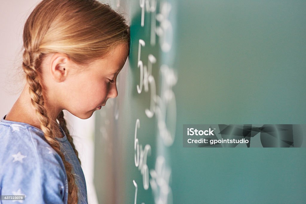 Schoolgirl trying to understand formula Mathematics Stock Photo