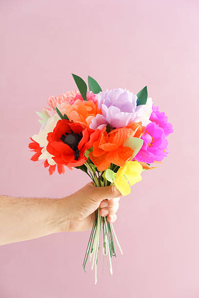 Hand holding paper flowers