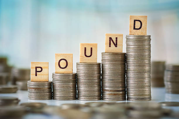 istock Stack of Coins with Wooden Letters 637223762