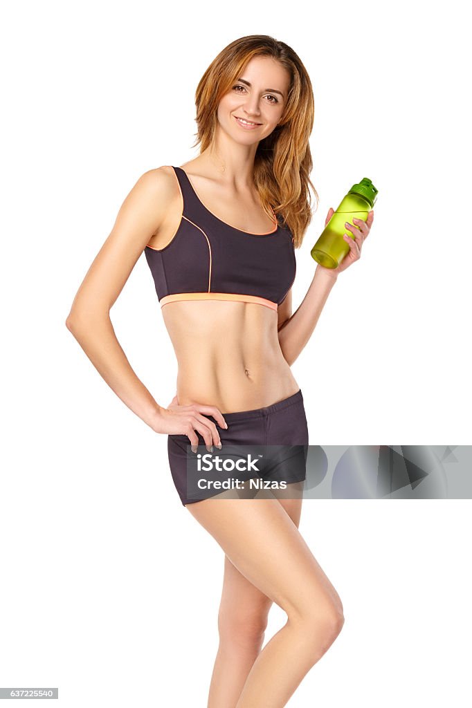 sexy woman in sport bra and panties holding sport bottle and
