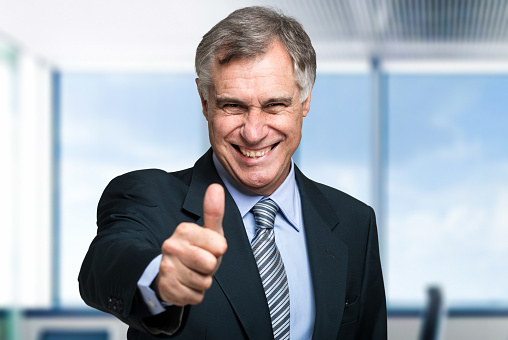 Businessman doing thumbs up sign