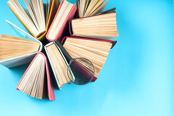 istock Top view of bright colorful hardback books in a circle. 637226024