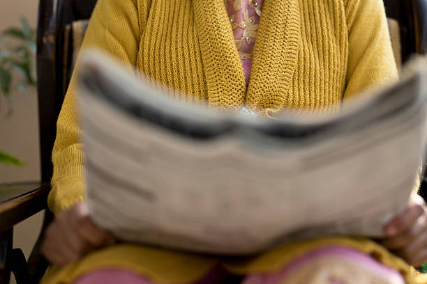 istock Woman reading newspaper 637229168