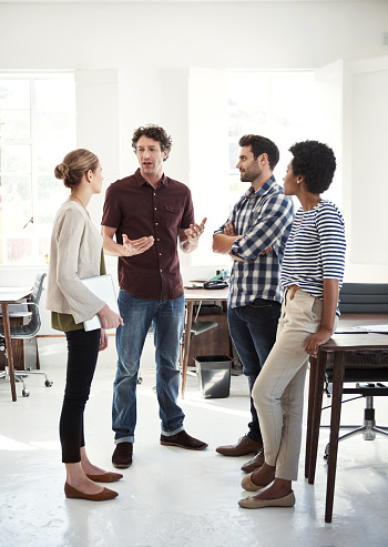 Shot of a team of designers working together in an office