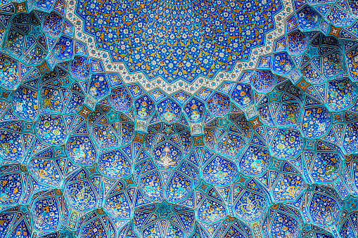 Ceiling and wall tilework at the Shah Mosque on Imam Square, Isfahan, Iran. The mosque is also known as Imam Mosque and Jaame' Abbasi Mosque. It is one of the masterpieces of Iranian/Persian Architecture and an excellent example of Islamic era architecture of Iran and also one of the top sights of the contry.