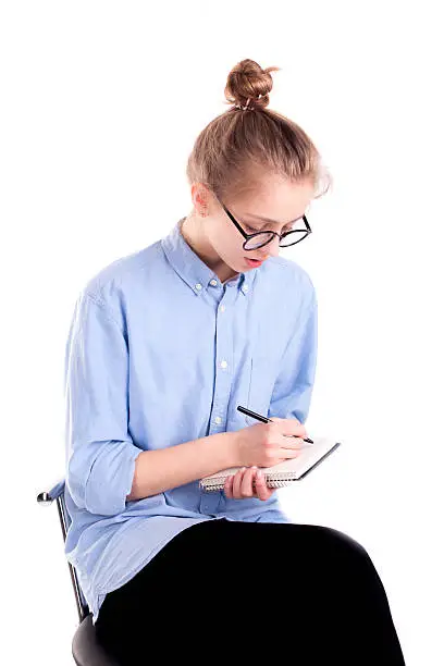 Photo of Journalist girl white text in notepad isolated