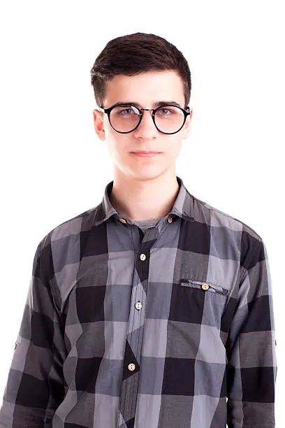 Photo of Handsome student boy posing in studio isolated