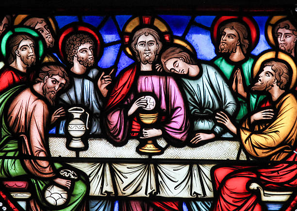 Last Supper - Stained Glass Brussels, Belgium - July 26, 2012: Stained glass window depicting Jesus and the twelve apostles on maundy thursday at the Last Supper in the cathedral of Brussels, Belgium. apostle worshipper photos stock pictures, royalty-free photos & images