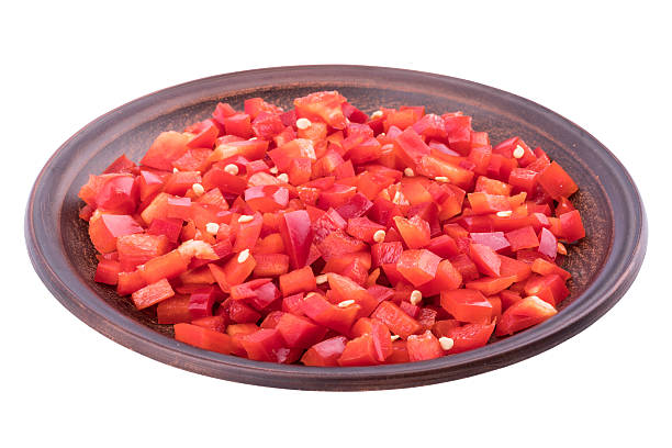 istock Sliced red pepper in a brown ceramic plate. 637232748