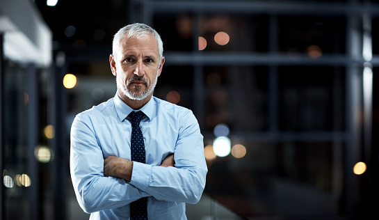 Portrait of a confident and mature businessman working in a modern office