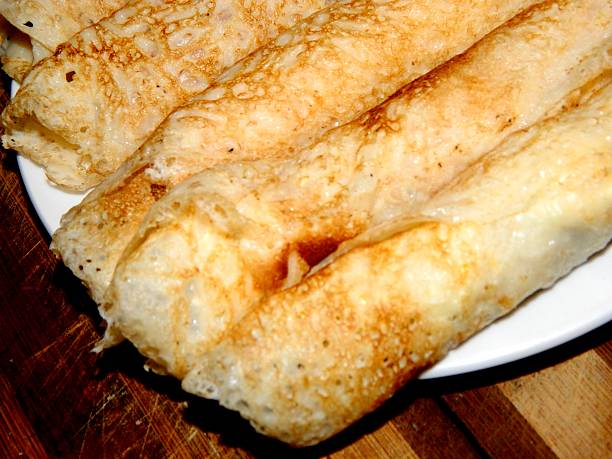 istock thin pancakes rolled in a tube lie on a plate 637234638