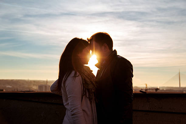 istock Couple looking on the rooftop at the sunset 637234924