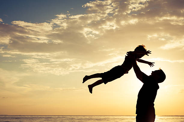 istock Father and son playing on the beach at the sunset 637238172
