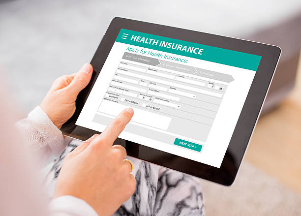 health insurance application on tablet - health insurance imagens e fotografias de stock