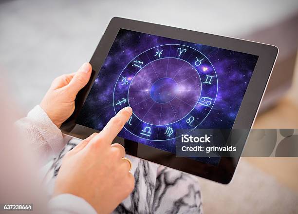 Photo libre de droit de Femme Lisant Des Horoscopes Sur Tablette banque d'images et plus d'images libres de droit de Astrologie - Astrologie, Signes du Zodiaque, Prédire l'avenir