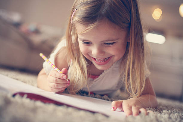 istock Little  girl writing  at home. 637240100