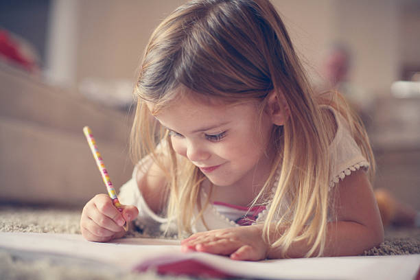 istock Little  girl writing  at home. 637240244