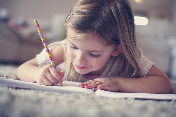 istock Little  girl writing  at home. 637240330