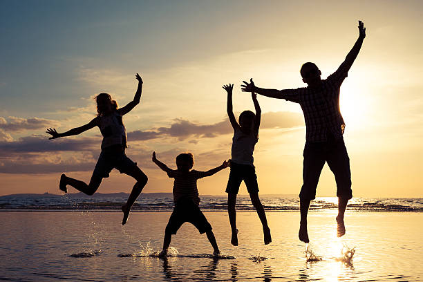 istock Father and children playing on the beach at the sunset 637240406