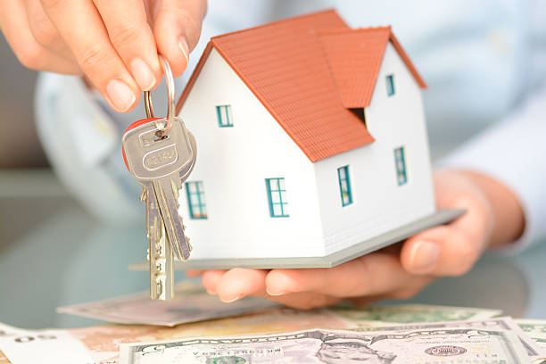 istock Buying a house concept with  model house and keys 637244704