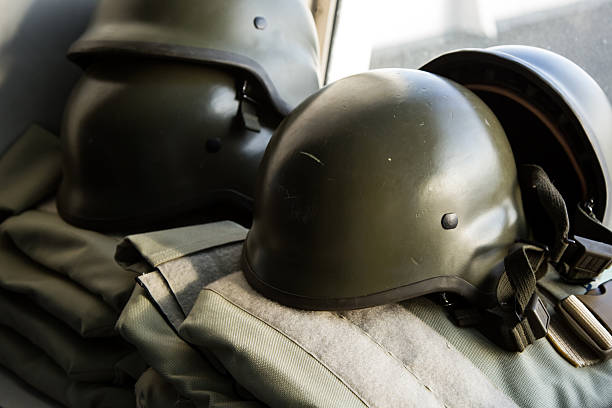 istock Military helmets with ammunition background 637245660
